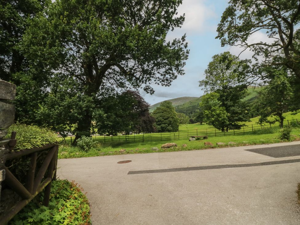 A view of trees and mountains in the countryside at Two Hollens in Grasmere
