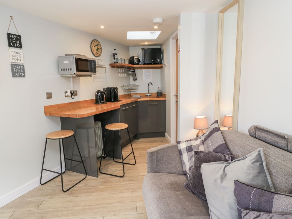 A kitchen with a microwave and coffee maker at The Chill Garden Room in Shepton Mallet