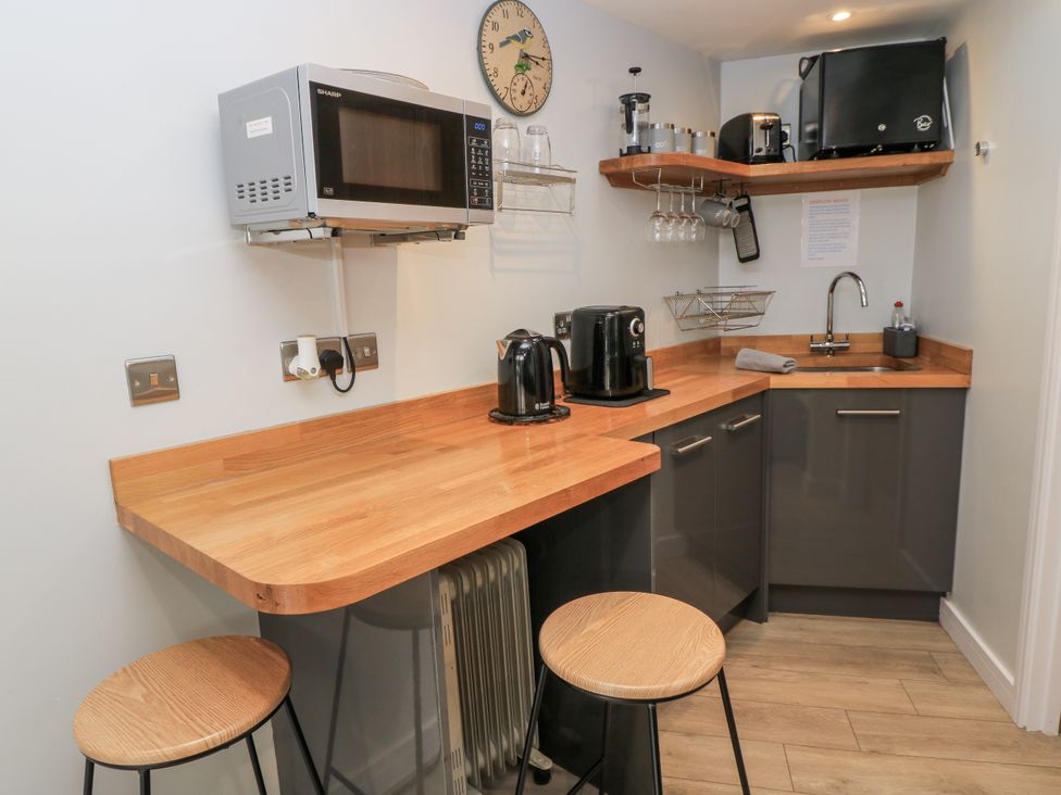 A kitchen with counter space and appliances at The Chill Garden Room in Shepton Mallet