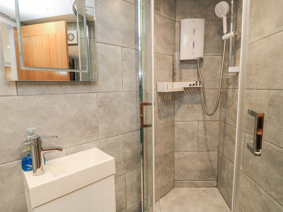 A bathroom with a shower and toilet sink at The Chill Garden Room in Shepton Mallet