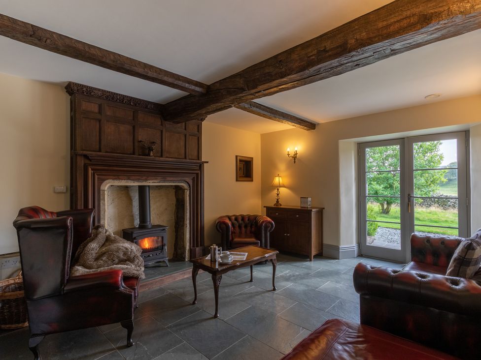 A living room with a fireplace and furniture at Souterstead in Torver near Coniston