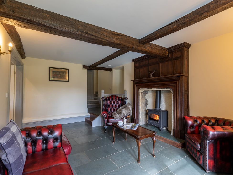 A living room with a fireplace and sofas at Souterstead in Torver near Coniston