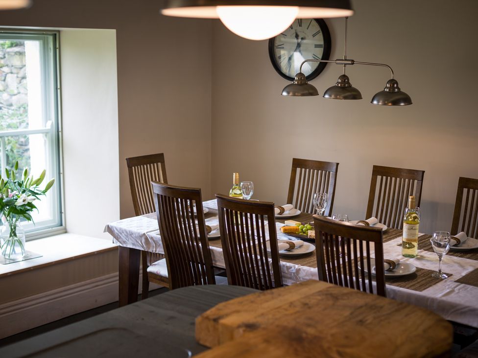 A dining room with a large table set for a meal at Souterstead in Torver near Coniston