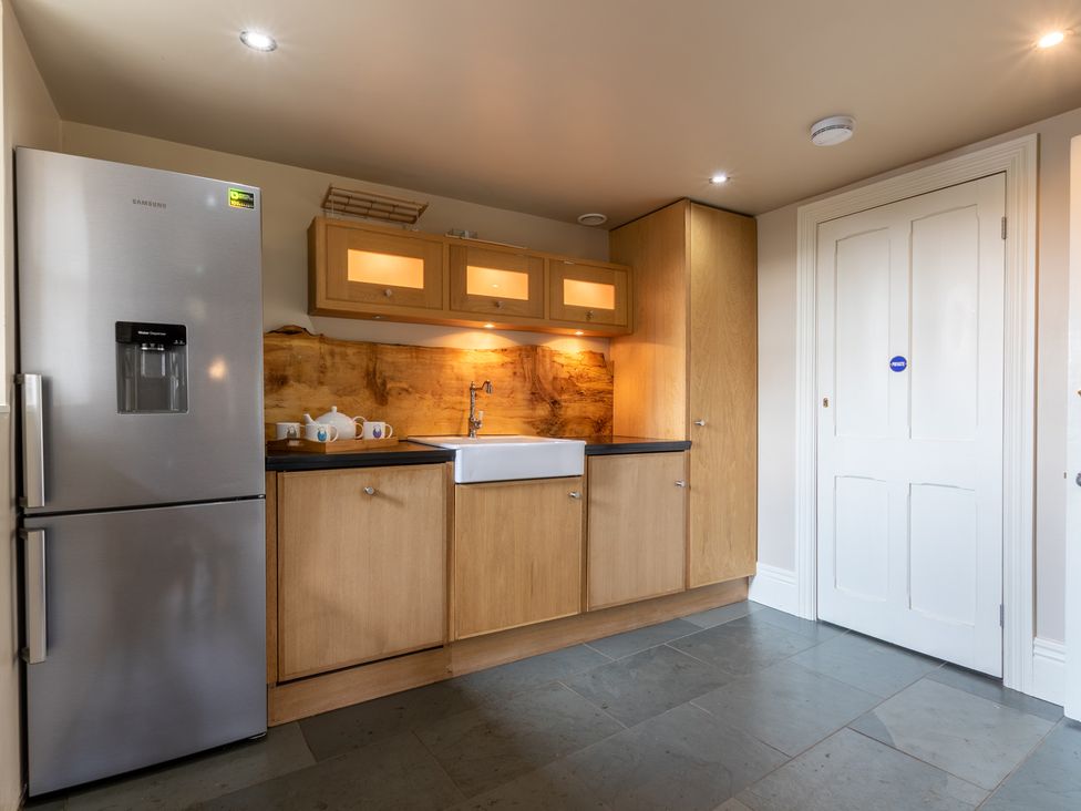 A kitchen with a refrigerator and sink at Souterstead in Torver near Coniston
