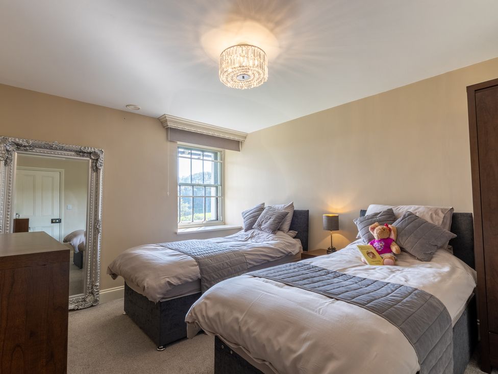 A bedroom with twin beds and a teddy bear at Souterstead in Torver near Coniston