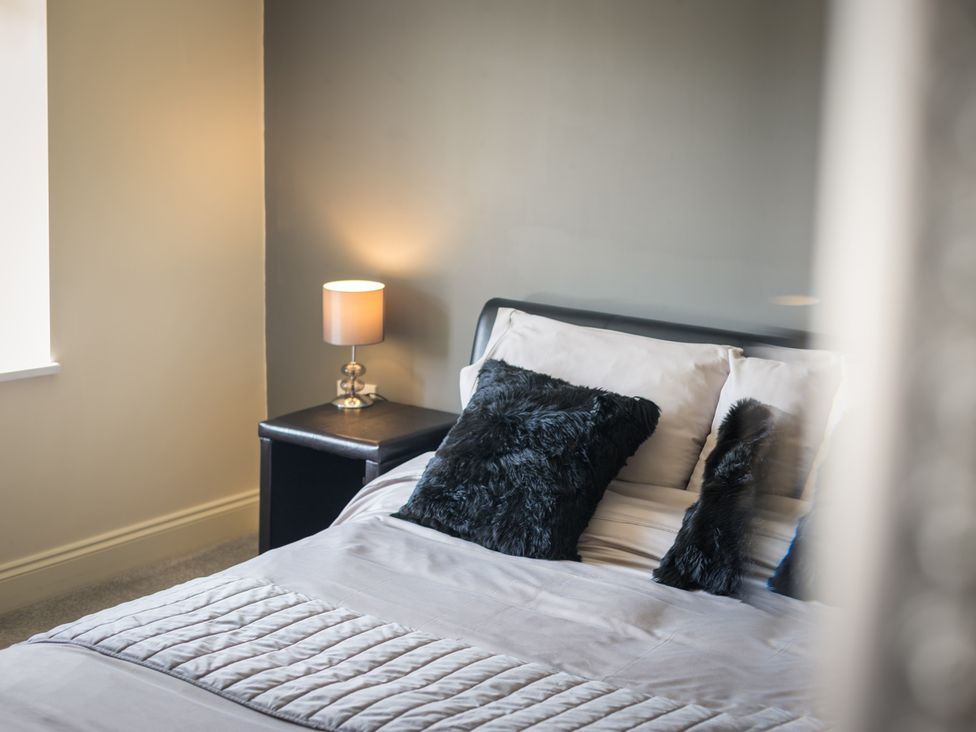 A bedroom with a bed and a bedside lamp at Souterstead in Torver near Coniston