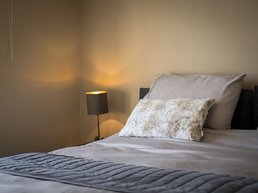 A bedroom with a bed and lamp at Souterstead in Torver near Coniston