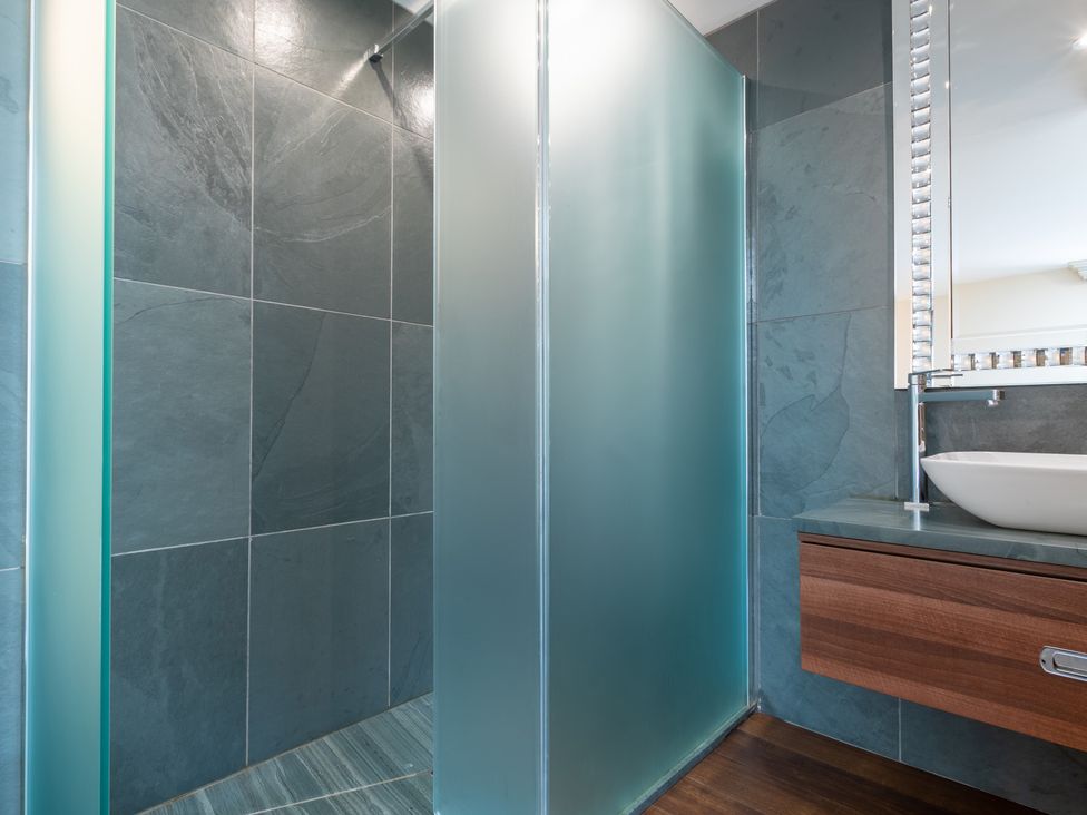A bathroom with a shower and sink at Souterstead Torver near Coniston