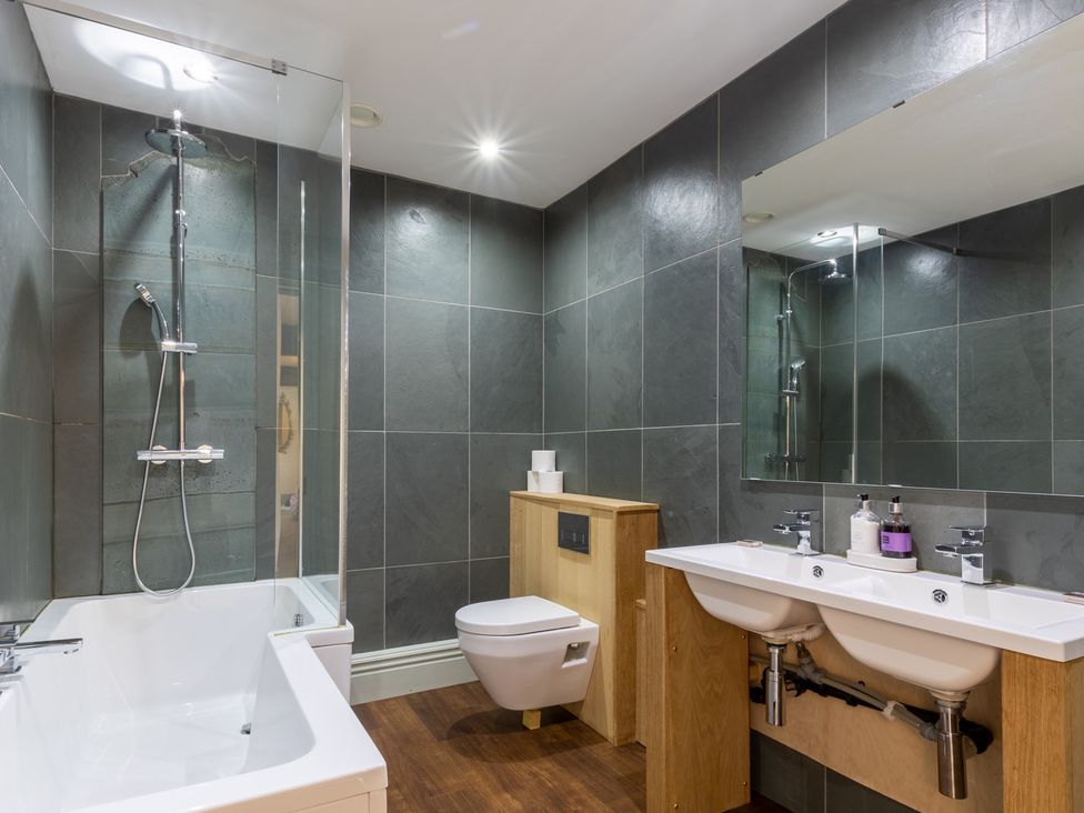 A bathroom with a bathtub and shower at Souterstead in Torver near Coniston