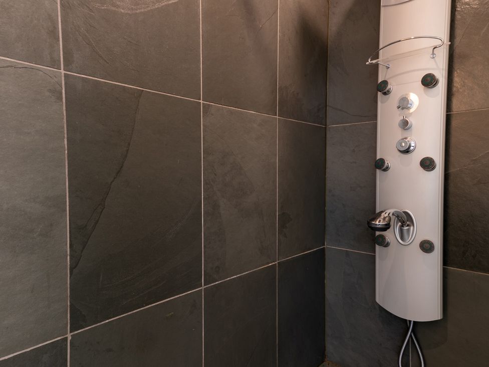A shower area with a shower panel and tiles at Souterstead in Torver near Coniston