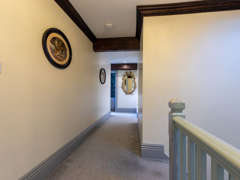 A hallway with a mirror and wall art at Souterstead in Torver near Coniston