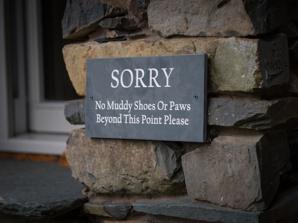 A sign indicating no muddy shoes or paws beyond this point at Souterstead, Torver near Coniston