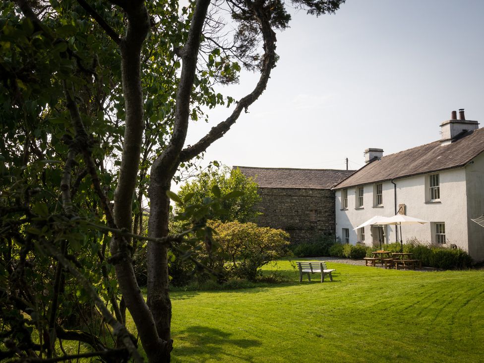 A house and garden with trees and seating at Souterstead Torver near Coniston