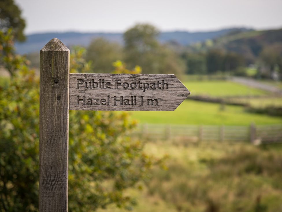 A wooden signpost indicating a public footpath at Souterstead in Torver near Coniston