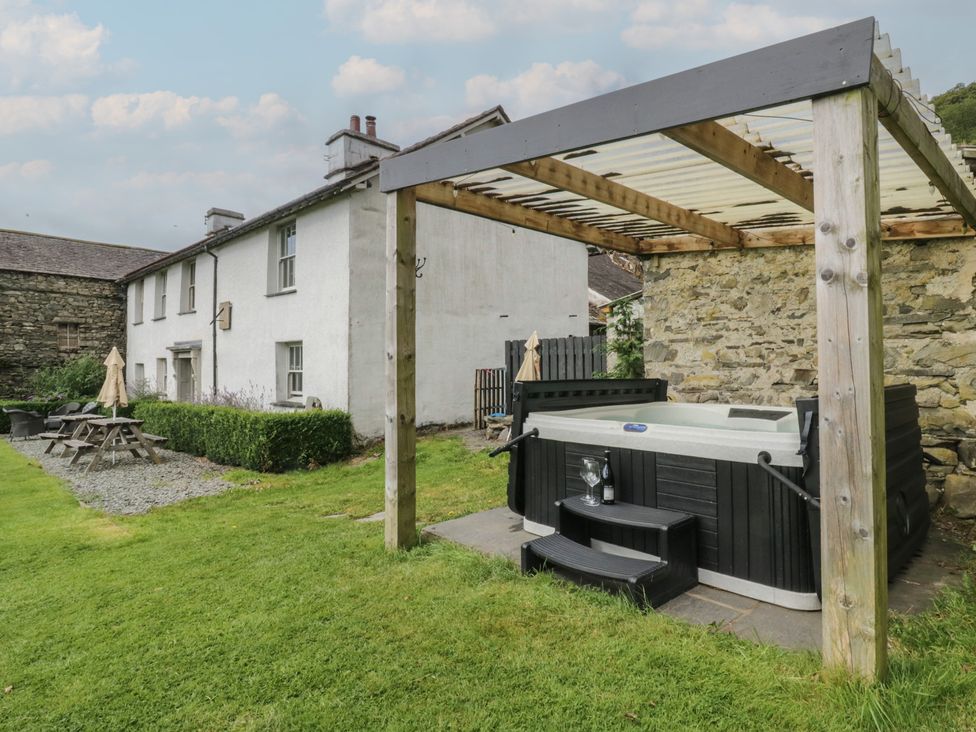 A garden with a hot tub and patio furniture at Souterstead in Torver near Coniston