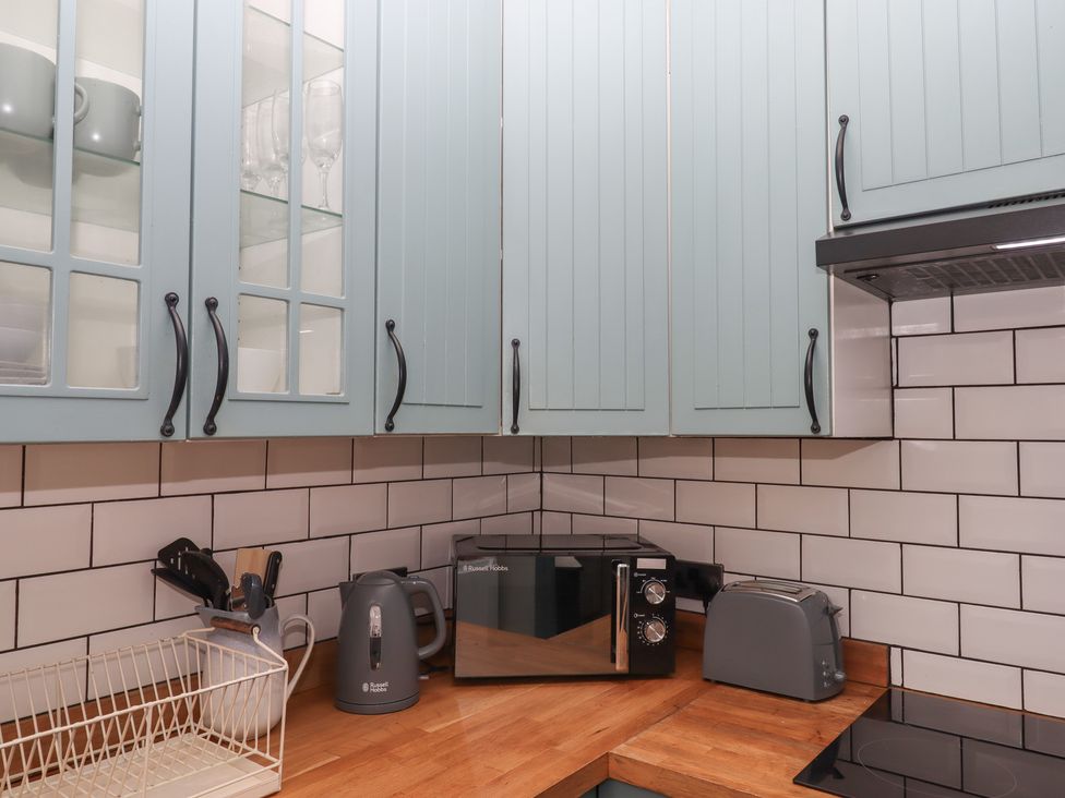 A kitchen with cabinets, microwave, kettle, and toaster at Home by the Harbour in Dartmouth