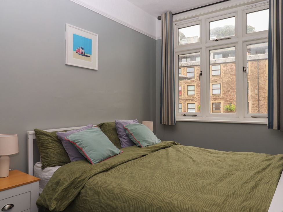 A bedroom with a bed and window at Home by the Harbour in Dartmouth