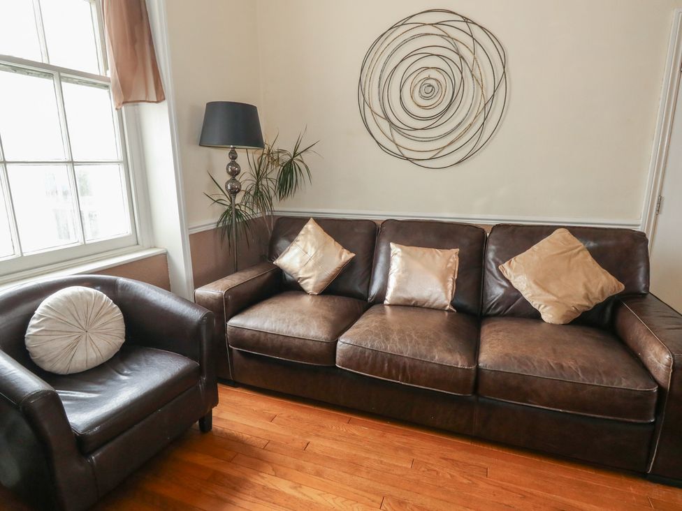 A living room with a sofa and armchair at 9 The Esplanade