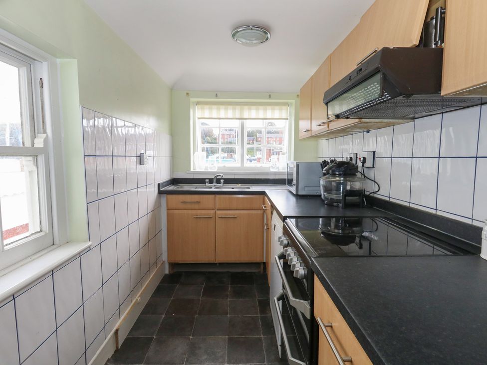 A kitchen with cabinets and appliances at 9 The Esplanade