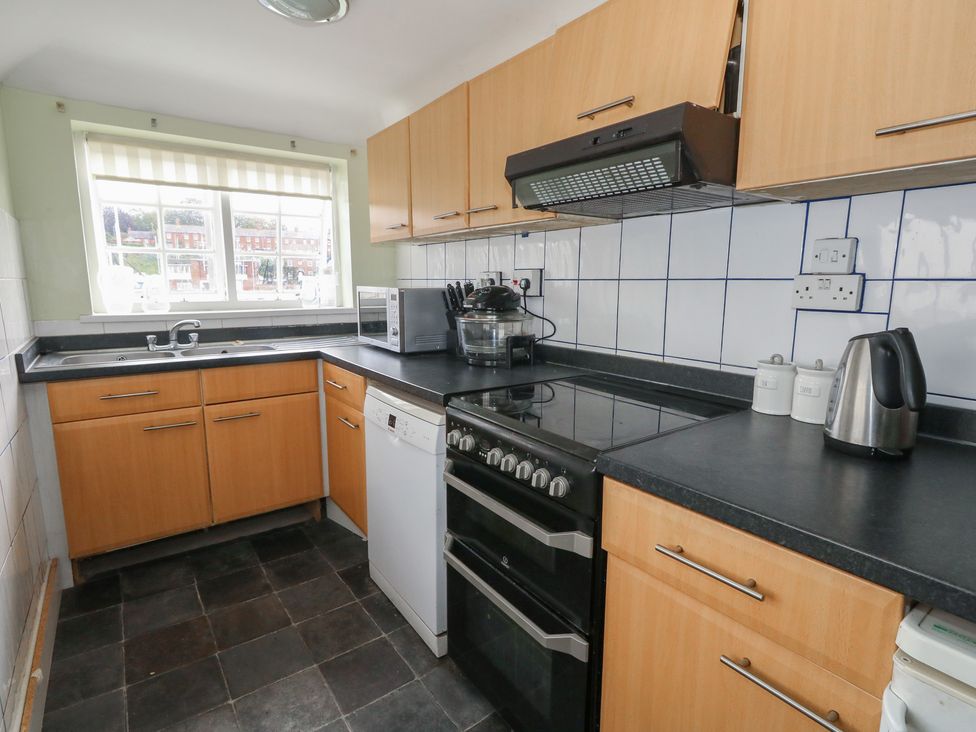 A kitchen with appliances and cabinets at 9 The Esplanade