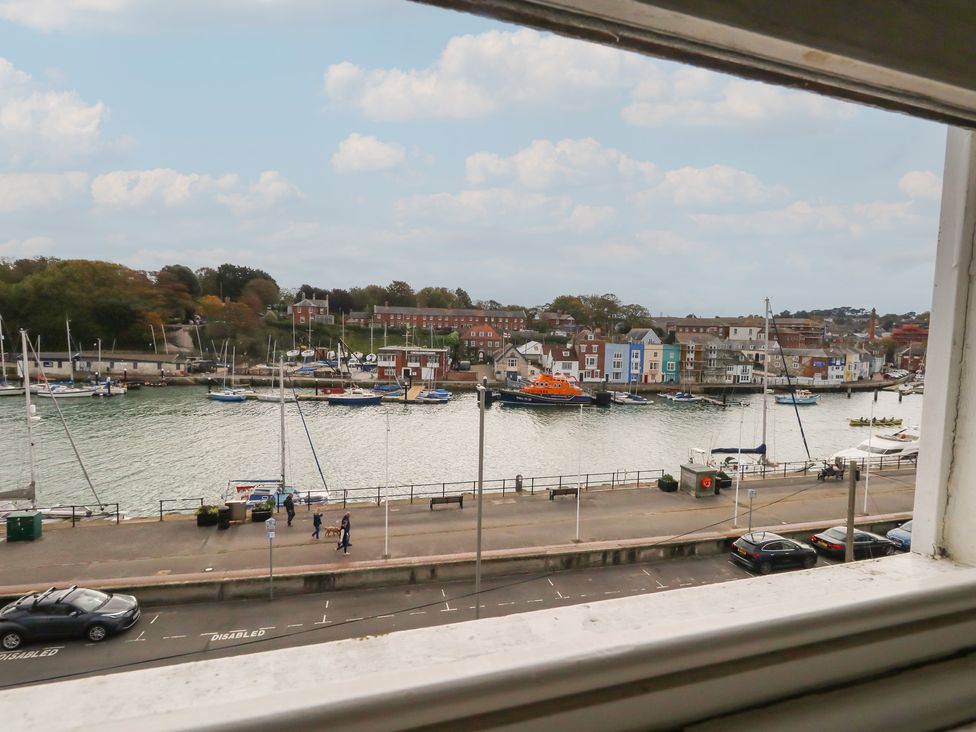 A view of a marina with boats and buildings at 9 The Esplanade in 