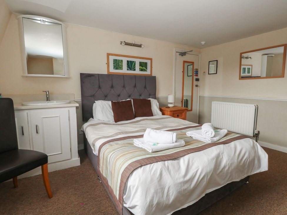 A bedroom with a bed and a desk at 9 The Esplanade