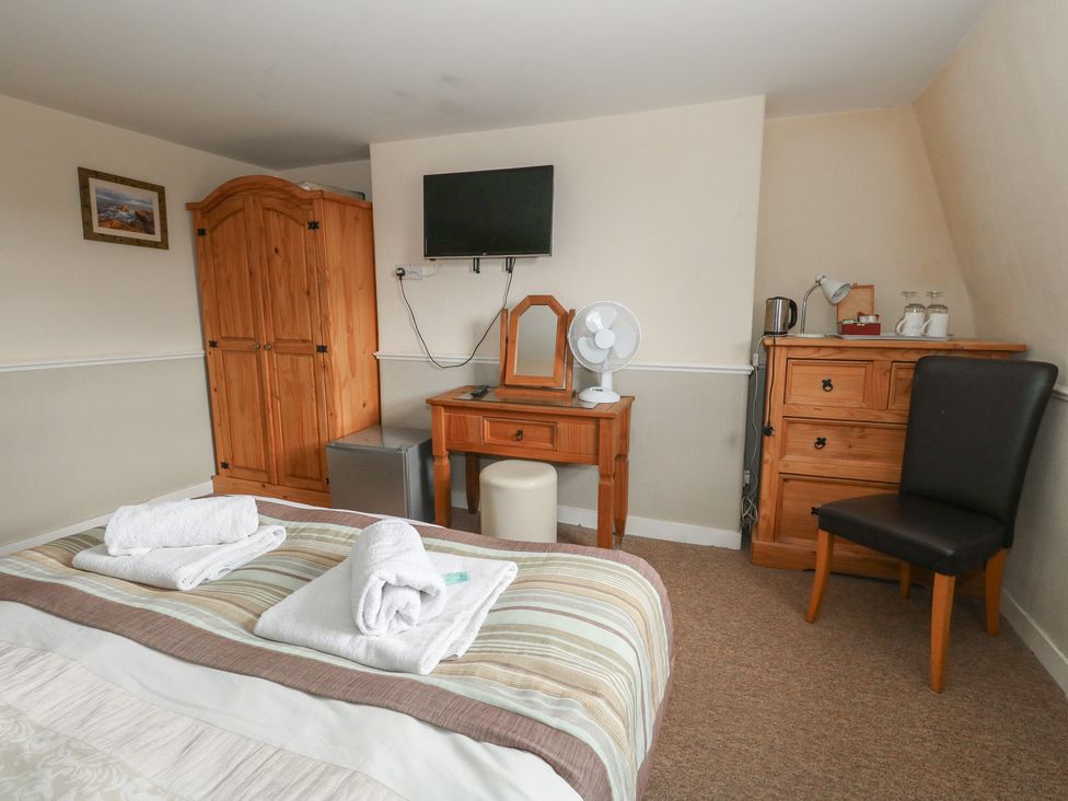 A bedroom with a bed and furniture at 9 The Esplanade 