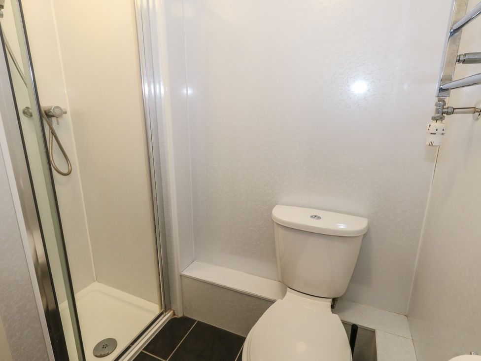 A bathroom with a shower and a toilet at 9 The Esplanade