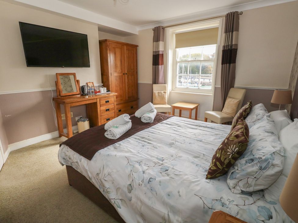 A bedroom with a bed and a television at 9 The Esplanade