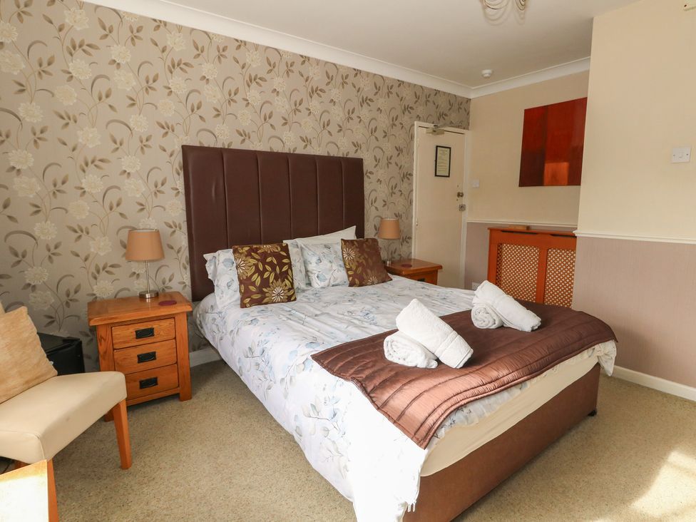 A bedroom with a bed and furniture at 9 The Esplanade