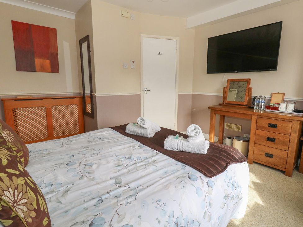 A bedroom with a bed and television at 9 The Esplanade