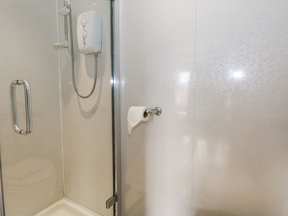 A shower area with a shower head and control panel at 9 The Esplanade