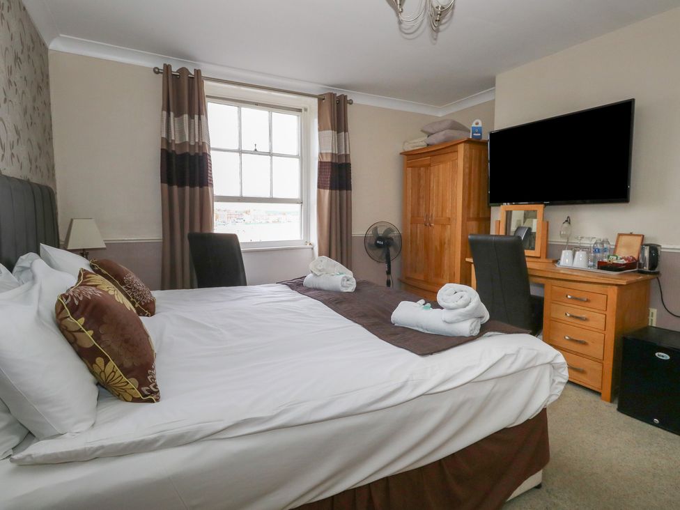 A bedroom with a bed and a television at 9 The Esplanade