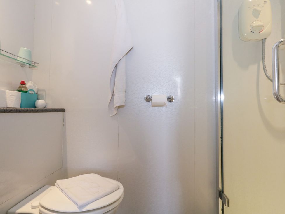 A bathroom with a toilet and shower at 9 The Esplanade