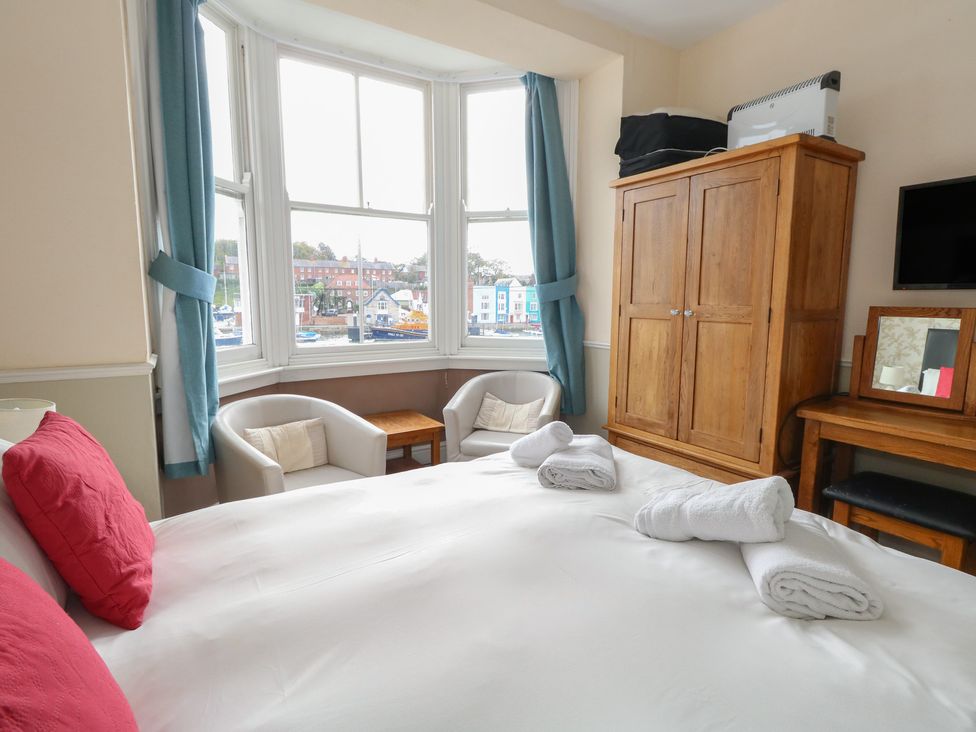 A bedroom with a bed and furniture at 9 The Esplanade 