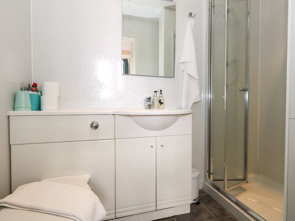 A bathroom with a shower and vanity unit at 9 The Esplanade