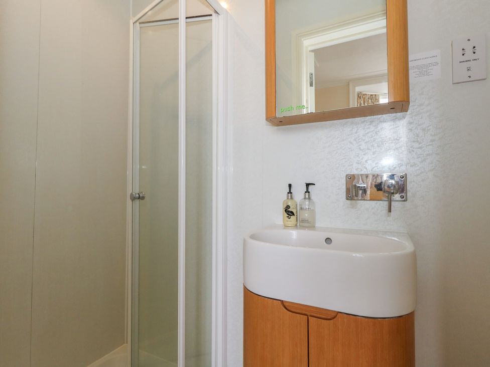 A bathroom with a shower and a sink at 9 The Esplanade