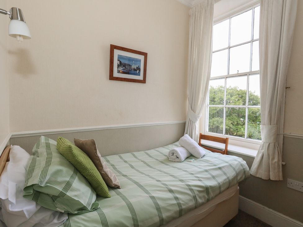 A bedroom with a single bed and a window at 9 The Esplanade