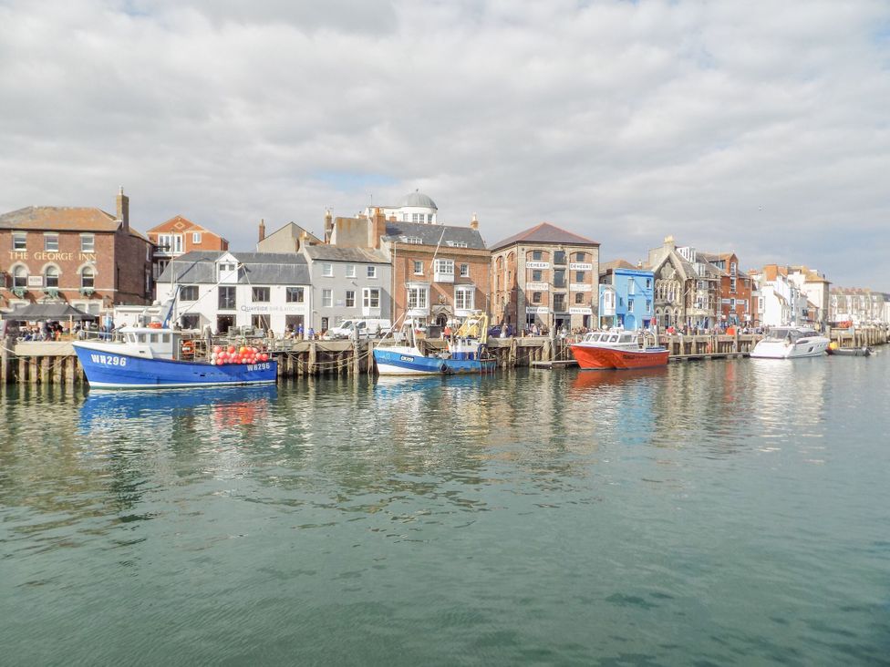 A harbor with boats and buildings at 9 The Esplanade