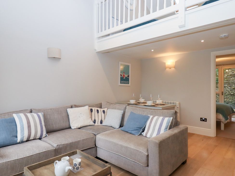 A living room with a sofa and coffee table at 3 Keepers Cottage