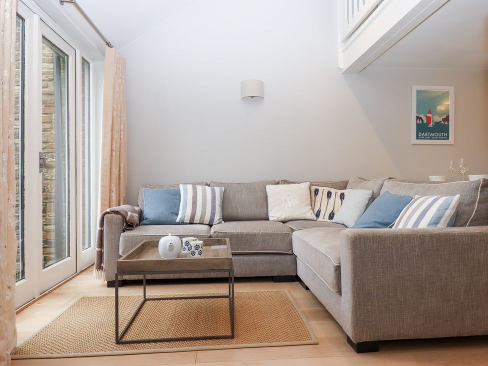 A living room with a sofa and coffee table at 3 Keepers Cottage 