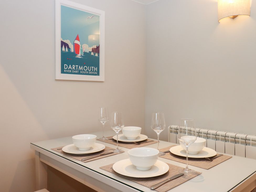 A dining room with bowls and glasses set on a table at 3 Keepers Cottage