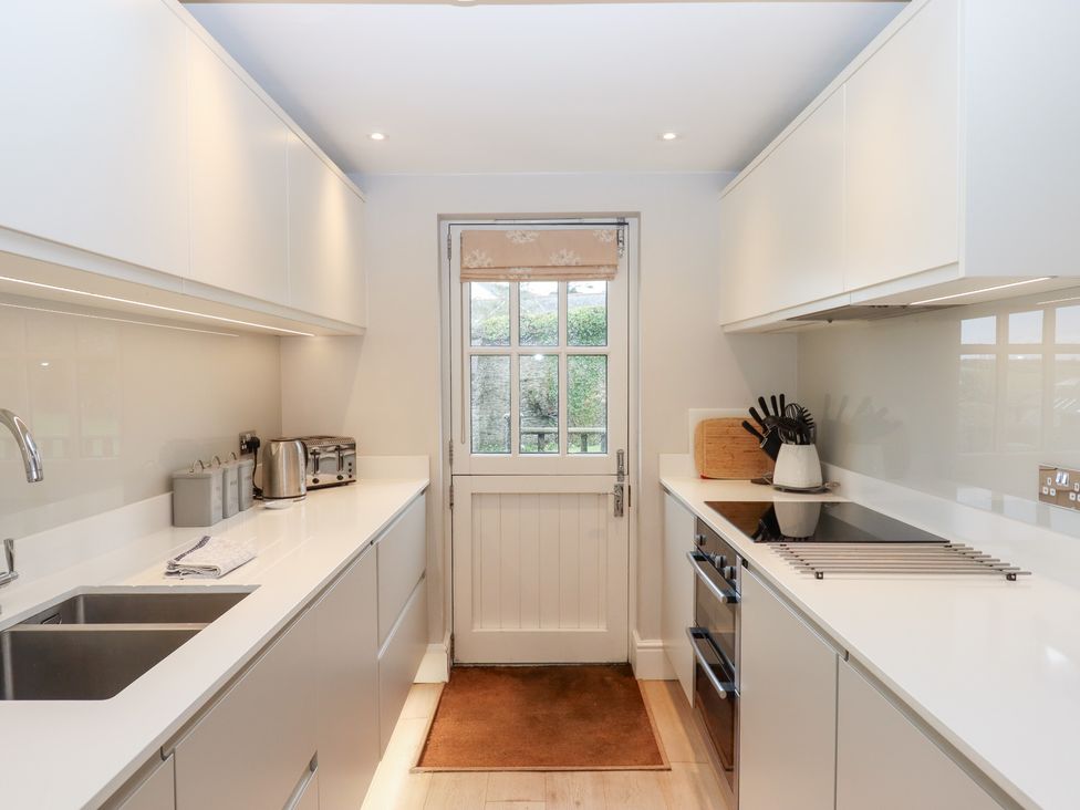 A kitchen with a sink and appliances at 3 Keepers Cottage