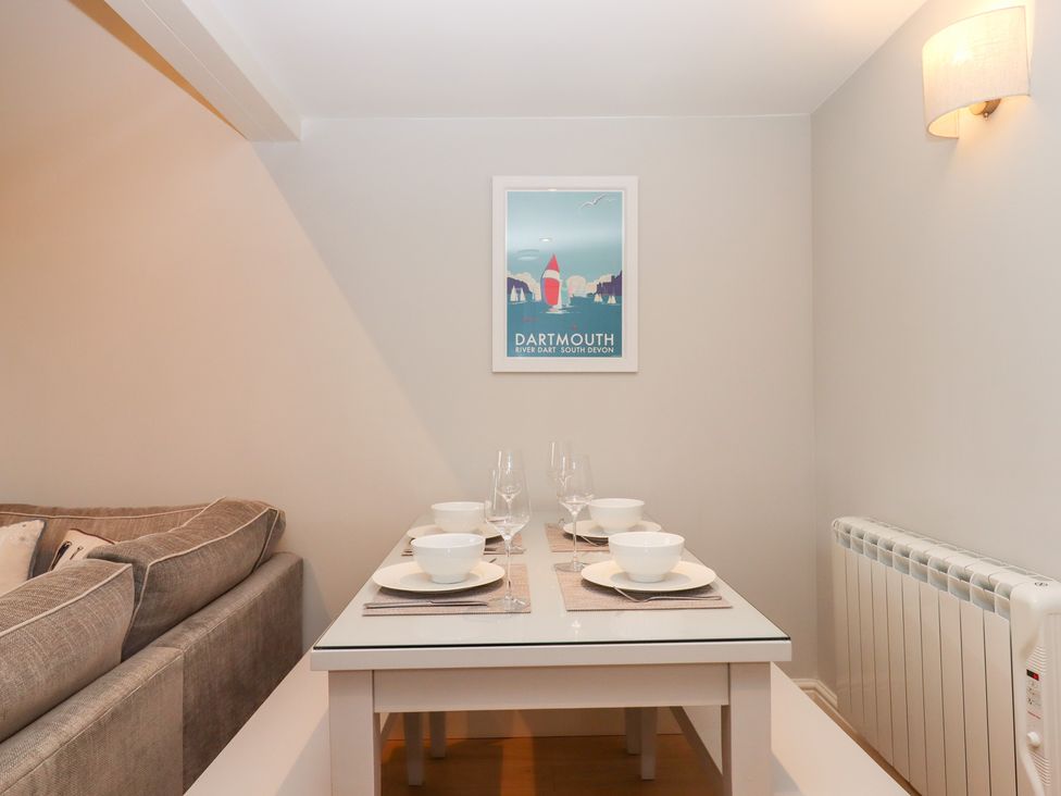 A dining room with a table set in front of a sofa at 3 Keepers Cottage
