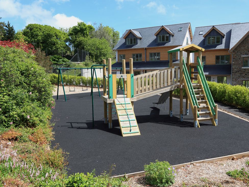 A playground with climbing frame and swing set at 3 Keepers Cottage