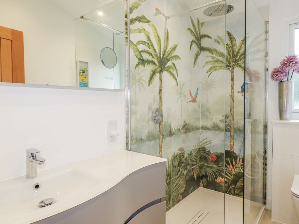 A bathroom with a shower and sink at Minack Lodge in Redruth
