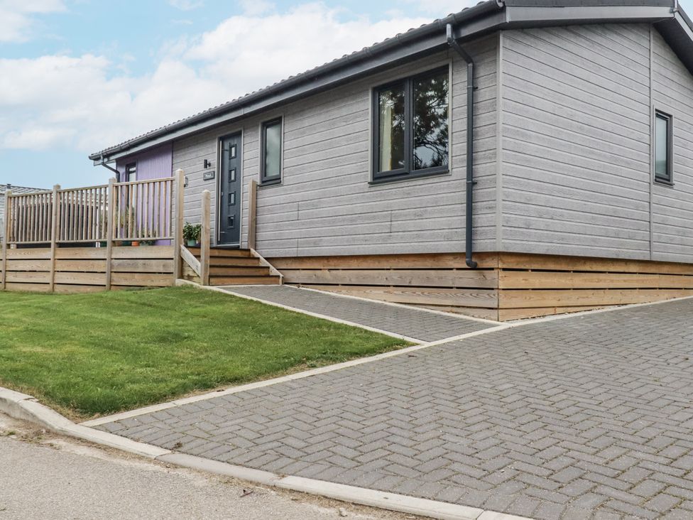 A house with a porch and driveway at Minack Lodge Redruth