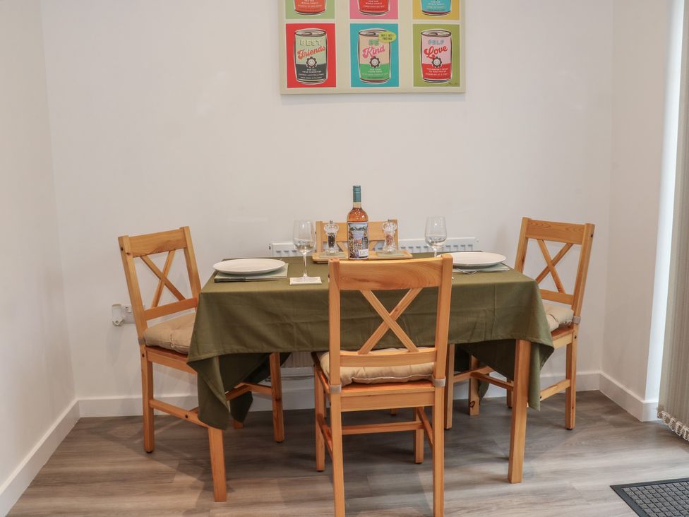 A dining room with a table set for a meal at Beach House Seaside Dunes in Lytham St. Annes