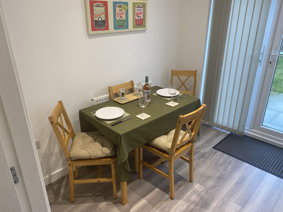 A dining room with a table set for four at Beach House Seaside Dunes in Lytham St. Annes
