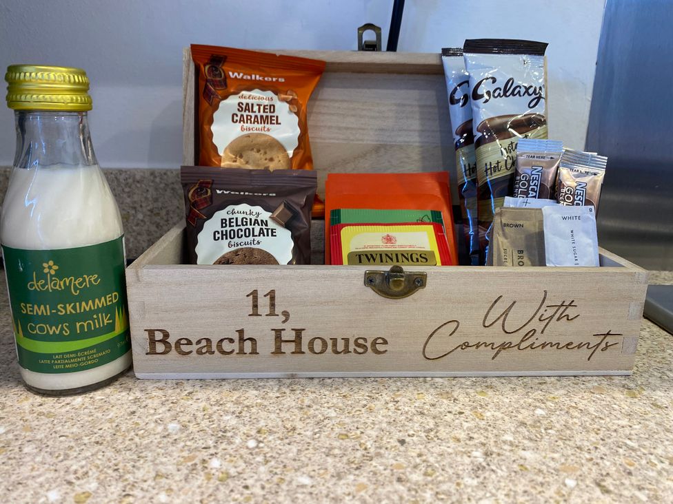A selection of tea, biscuits, and hot chocolate in a wooden box at Beach House Seaside Dunes in Lytham St. Annes